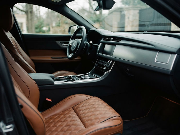 A freshly detailed luxury vehicle cabin with clean leather seats and a spotless dashboard