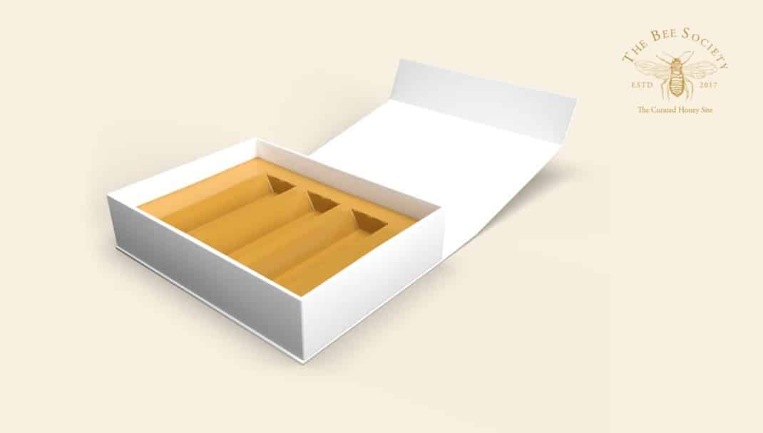 The open packaging design created for The Bee Society, shown empty.
