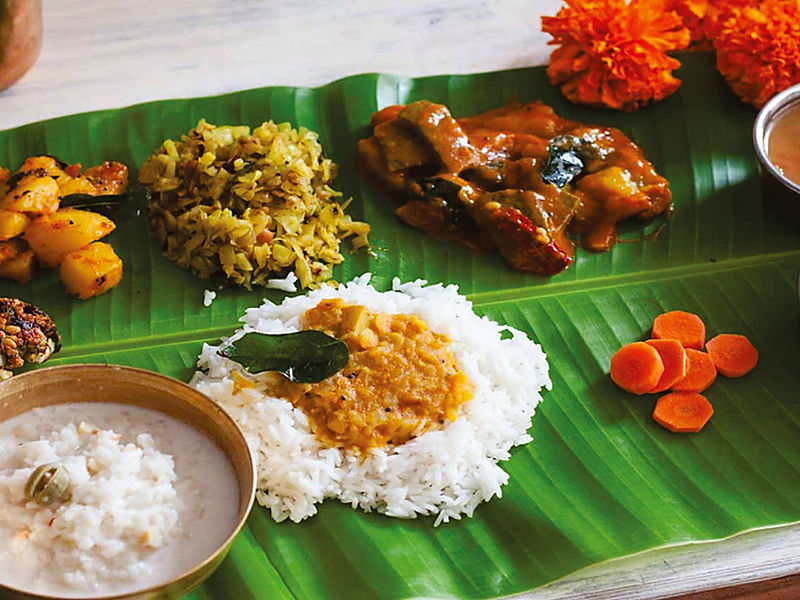 Traditional South Indian banana-leaf meal with rice, sambar, poriyal and curd, served by Namma Meenambiga Caterers