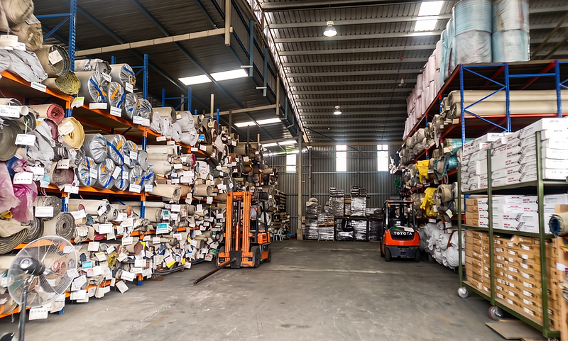 KK Floor warehouse hall with stocked shelving and forklifts