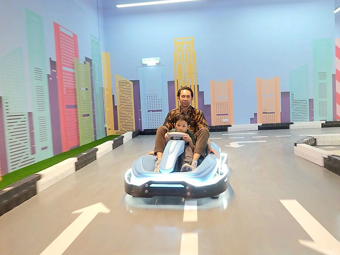 Parent and child driving together at VroomTown Malaysia