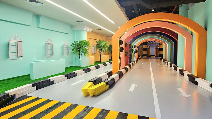 The rainbow tunnel road at VroomTown Singapore with yellow-and-black crossing stripes