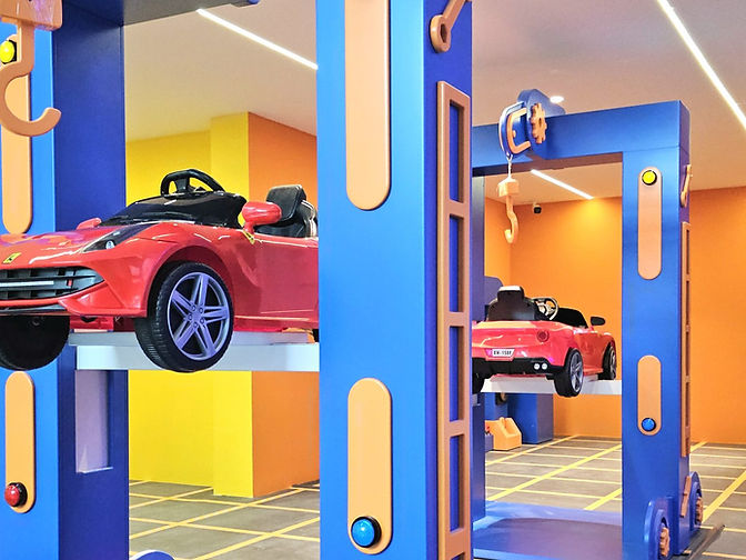 A themed car display and colourful entrance inside VroomTown at Atria Shopping Gallery