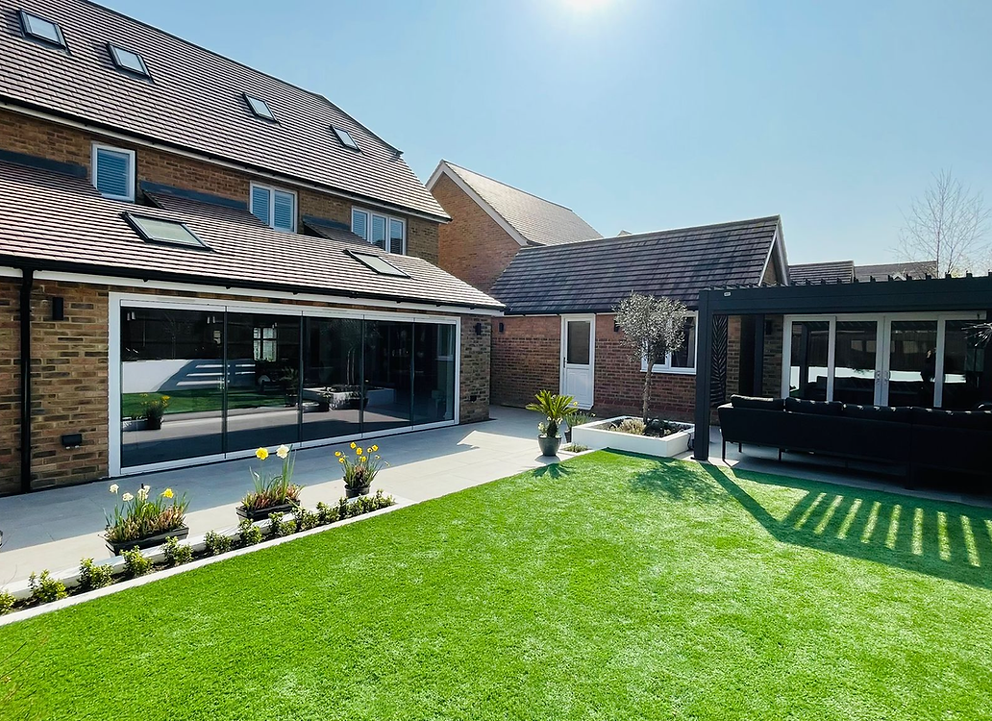 Sunlit rear extension with sliding glass doors and landscaped garden in Kent, built by Kent Building Contractors