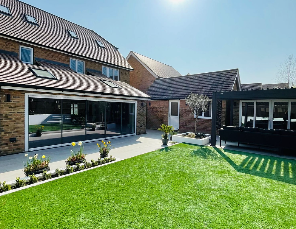 Sunlit rear extension with sliding glass doors and landscaped garden in Kent, built by Kent Building Contractors