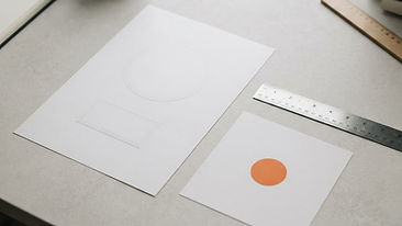 Blank logo design sample sheets in various sizes with a precision ruler and a small orange sticker