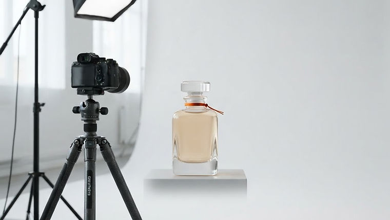 A professional product photography setup featuring soft lighting, a camera tripod, and an elegant perfume bottle on a clean white background.