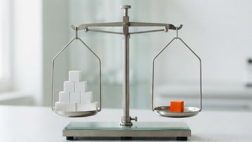 A simple balanced scale with white cubes on one side and an orange cube on the other