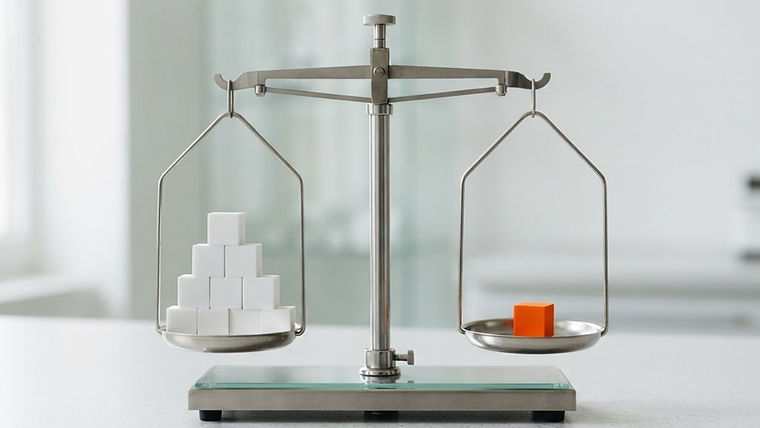 A simple balanced scale with white cubes on one side and an orange cube on the other