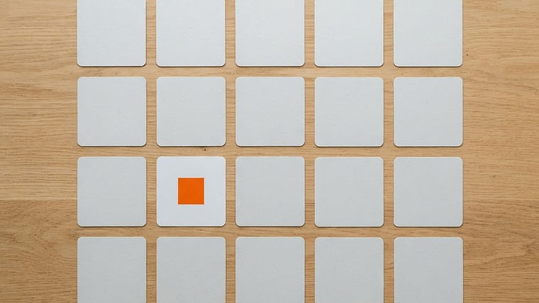 Blank square photo cards arranged as a social media grid on a light wooden table