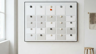 A weekly scheduling board with blank cards pinned by colorful magnets in a clean office setting