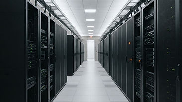 Data center aisle with symmetrical server racks under cool, calm lighting
