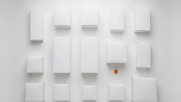 Top-down view of empty white product boxes arranged on a white background with a light diffuser panel