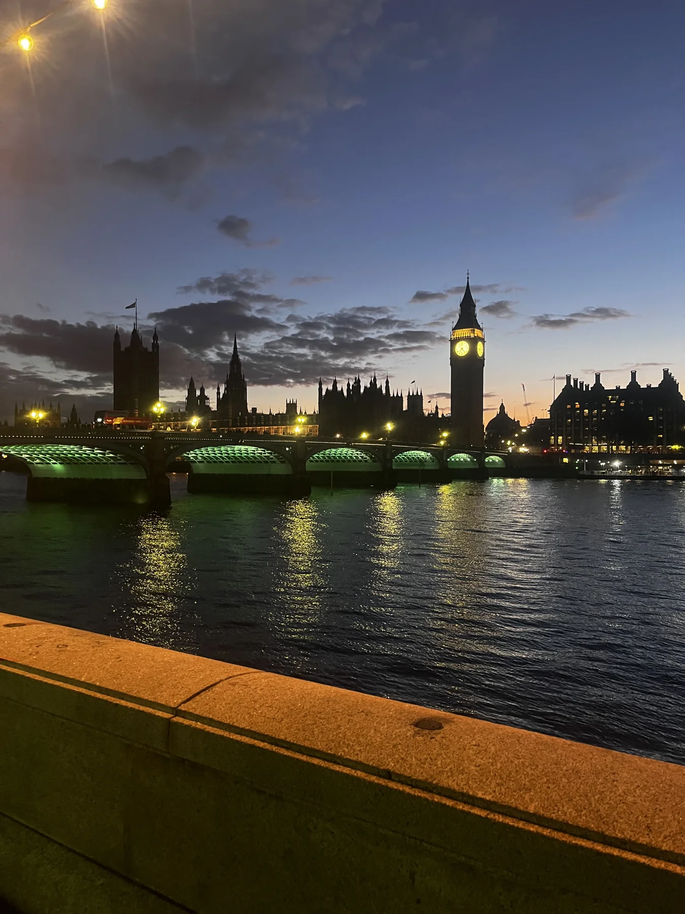Big Ben and Westminster Bridge reflected in the Thames at dusk
