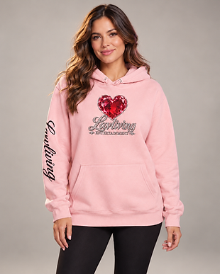 Woman wearing a pink Lavliving Ruby Heart hoodie with script branding, shown with her whole head and outfit visible.