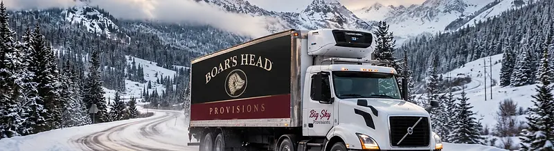 Big Sky Provisions refrigerated truck driving through a snowy Mountain West landscape