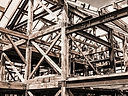 Structural steel frame of a modern commercial building under construction against a clear Alberta sky