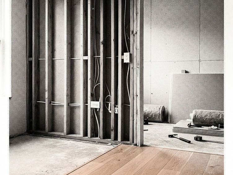 Finished open-plan renovation with warm oak flooring and matte black window frames
