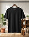 Unisex Relaxed Fit Cotton Blend Tee — Black (Black), lifestyle setting