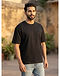 Unisex Relaxed Fit Cotton Blend Tee — Black (Black), worn or held by model
