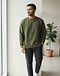 Unisex Premium Cotton Sweatshirt — Olive (Olive), worn or held by model
