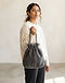 Unisex Fleece Drawstring Bag — Charcoal (Charcoal), worn or held by model