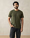 Unisex Heavyweight Premium Cotton Tee — Olive (Olive), worn or held by model