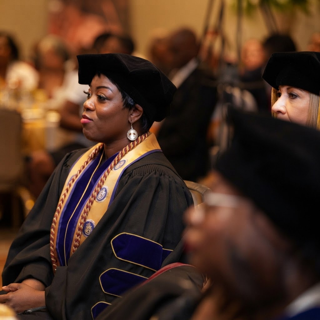 TIUAC graduate in academic regalia at a commencement ceremony