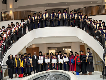 The TIUAC graduating class posed together on the grand ceremony staircase