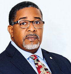 Official portrait of Dr. H. T. Mohair, President of Trinity International University of Ambassadors, wearing a navy suit and patterned tie