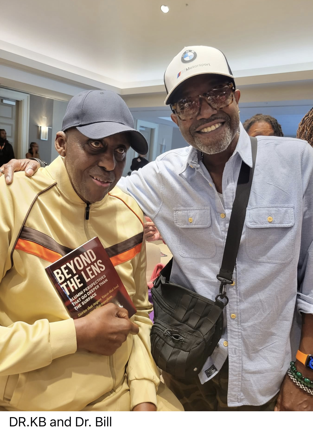 Dr. JB and Dr. Bill posing together with the Beyond the Lens book