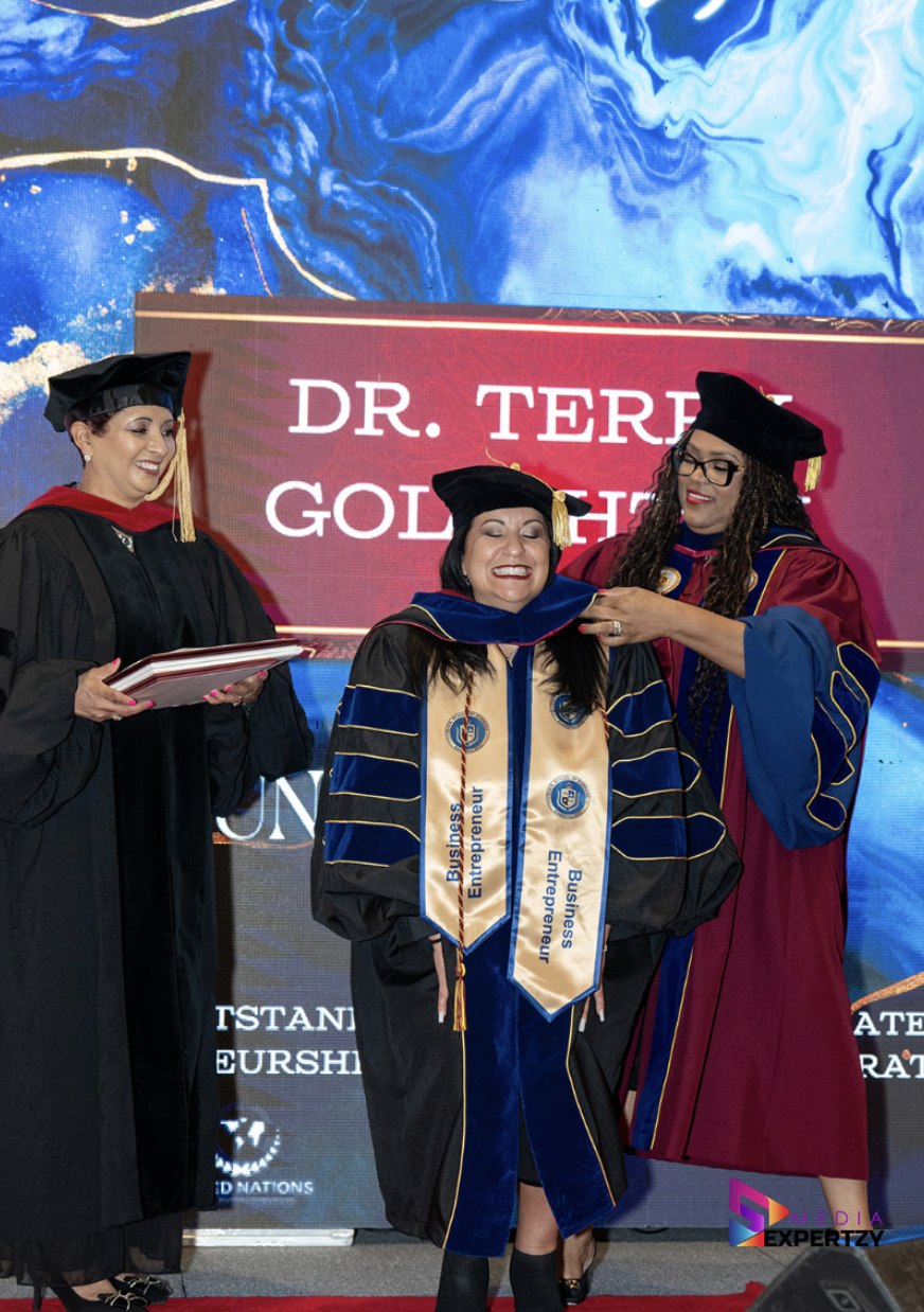 Graduates hooded on stage during the TIUAC conferral ceremony