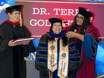 Graduates hooded on stage during the TIUAC conferral ceremony