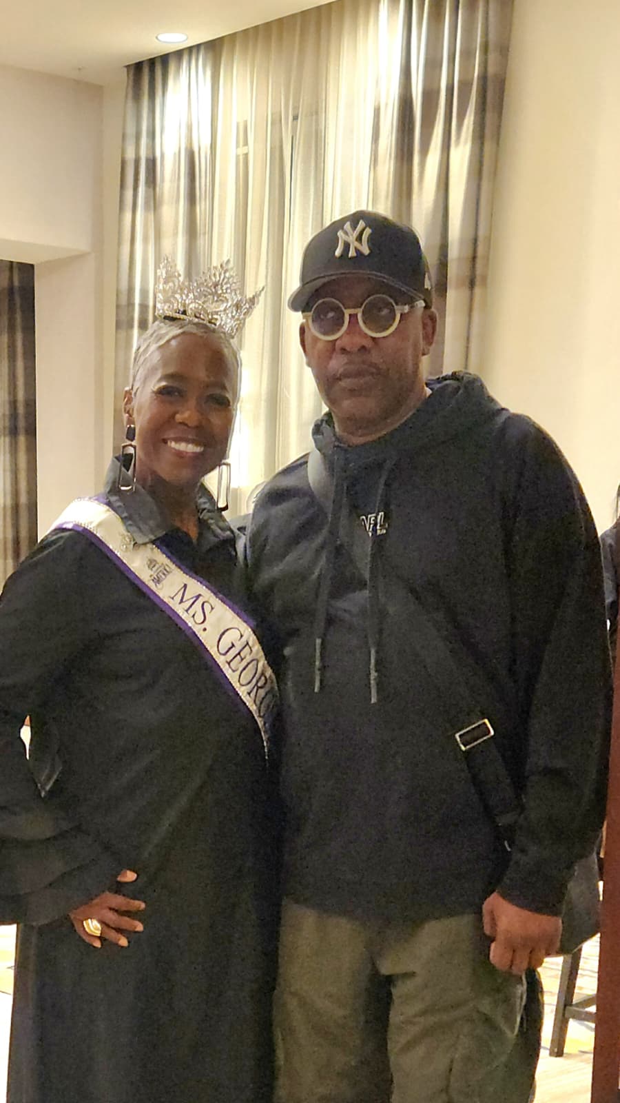 Ms. Georgia and a guest posing together at the celebration ballroom