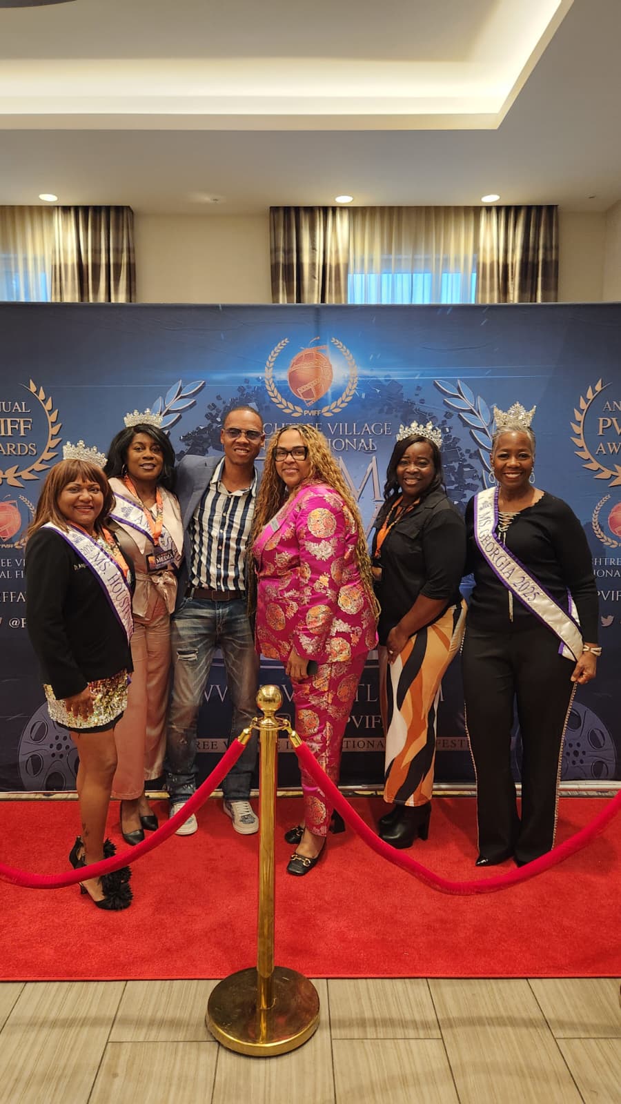 The delegation posing together on the Peachtree Village International Film Festival red carpet