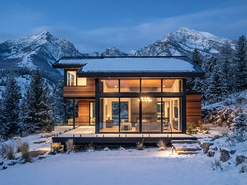 Modern mountain home at blue hour in snow-dusted Montana