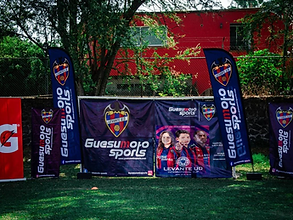 Banners de Guesumoto Sports y patrocinadores montados en el campo