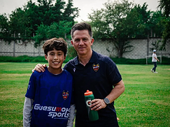 Joven jugador con entrenador del Levante UD posando en el campo
