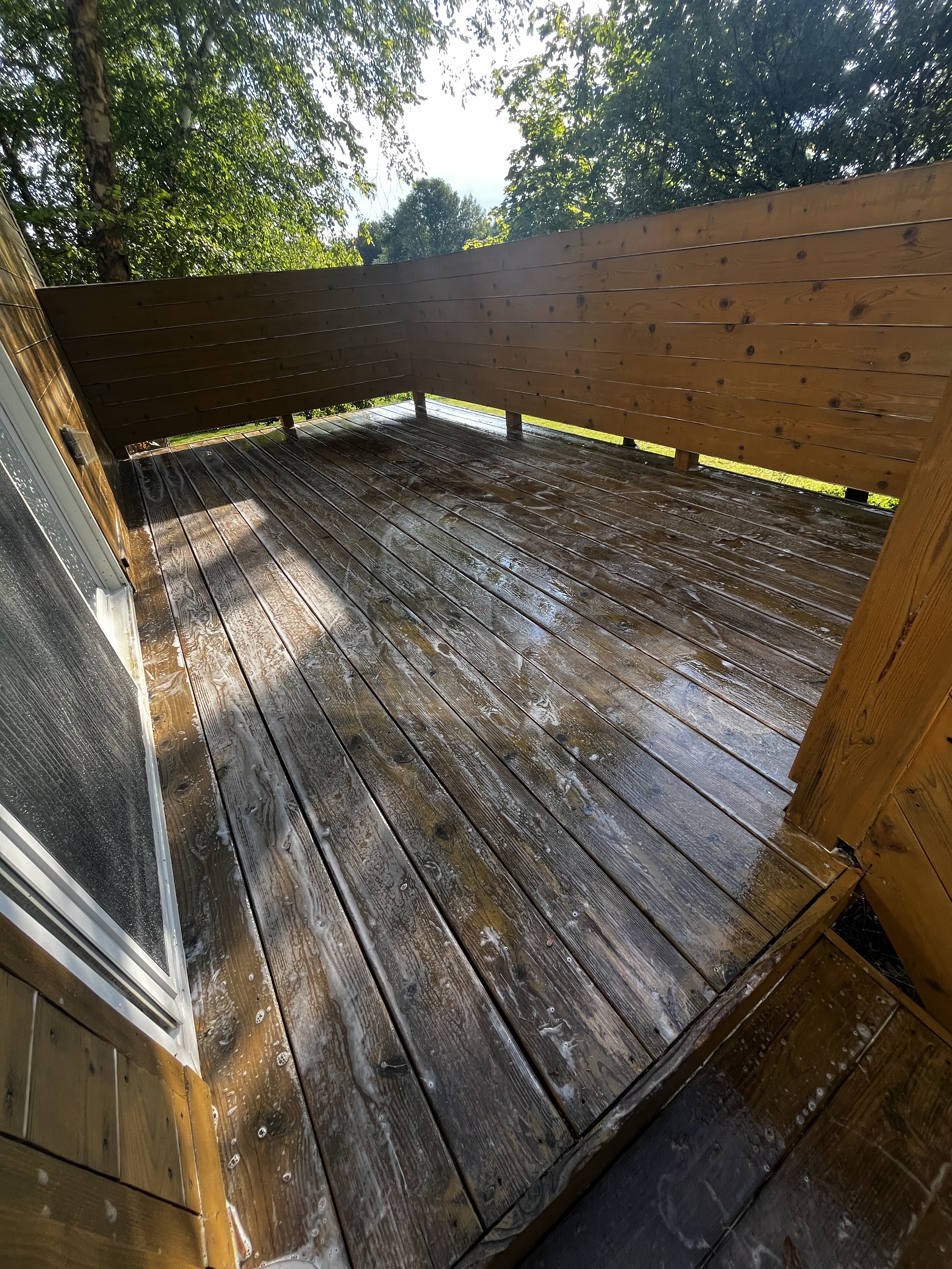 Wooden deck being washed with soap suds