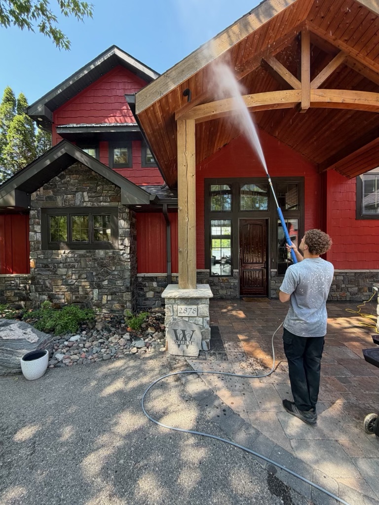 Crew power-washing the exterior of a home's entryway