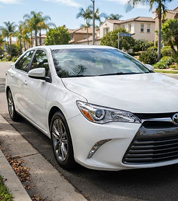 White Toyota Camry with clear restored headlights
