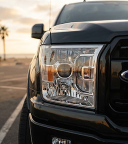 Restored clear headlight on a black Ford F-150
