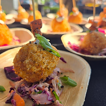 Plated fried bite with slaw on a bamboo plate