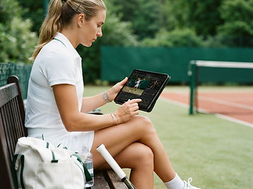 Player reviewing biomechanics analysis on a tablet courtside
