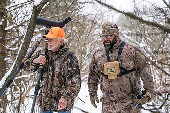Two hunters in camouflage gear during a winter shoot in Illinois