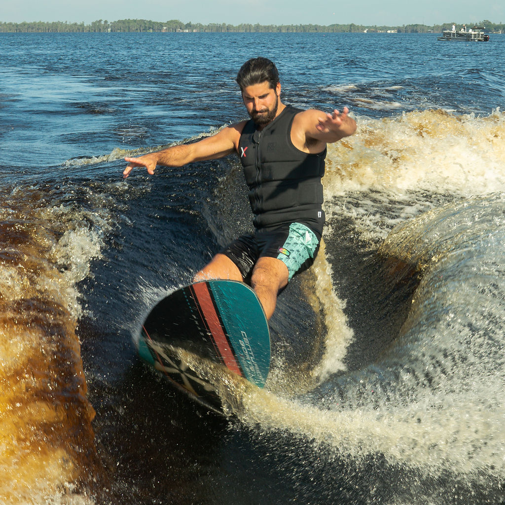 Wakesurfer riding a boat wake — outdoor sports photography by Overboard Media