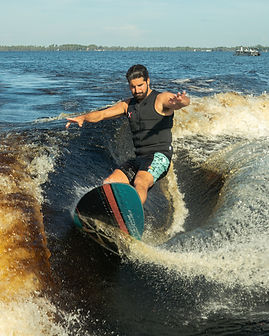Wakesurfer riding a boat wake — outdoor sports photography by Overboard Media