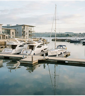 Yachts and motor boats moored in a smart UK coastal marina