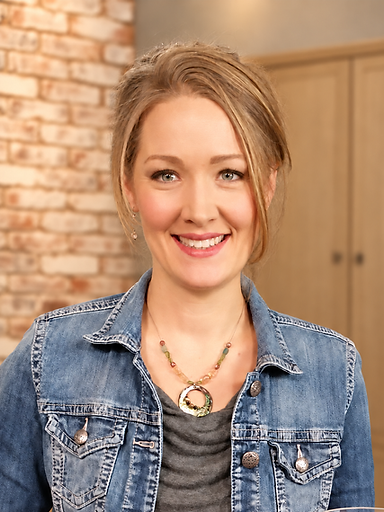 Erin, craniosacral therapist, in a sunlit studio holding a folded blanket