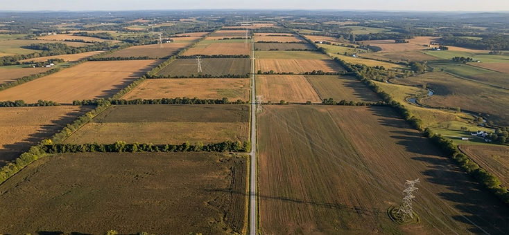 Aerial view of developable farmland divided by hedgerows and a transmission line easement